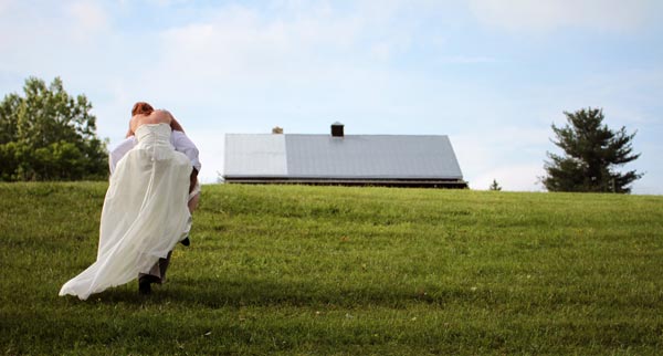 Bride and groom walking up a hill